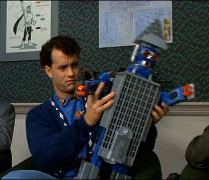 Tom Hanks from Big playing with a building that turns into a robot.